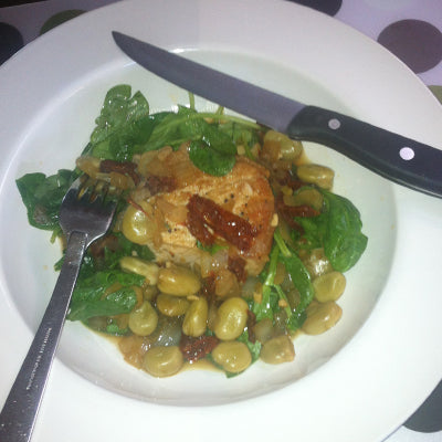 Image of Pork Loin Chops with Fava Beans Caramelized Onions, Slivered Tomatoes and Wilted Arugula