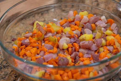 Image of diced potatoes and carrots in a mixing bowl