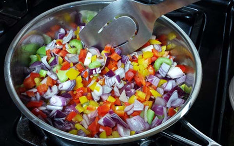 Image of Sauté onion, celery and peppers in a large deep fry pan in oil for about 5 minutes