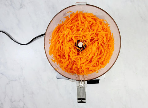 Image of shredded carrots on food processor bowl