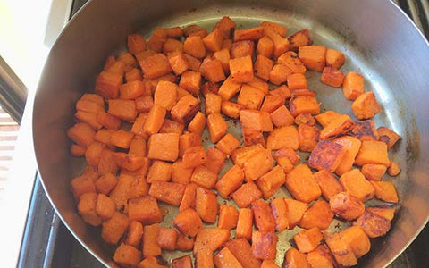 Image of Place 1 tsp. corn oil in a skillet and heat on medium heat. Add sweet potatoes and sprinkle with salt, chipotle chile powder and cumin