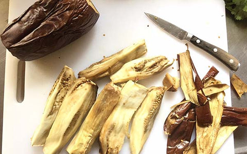 Image of When cool enough to handle, peel and discard eggplant skin. Remove most of the seeds and cut eggplant into chunks