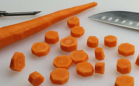 Image of Peel and slice carrots crosswise, medium thick pieces.