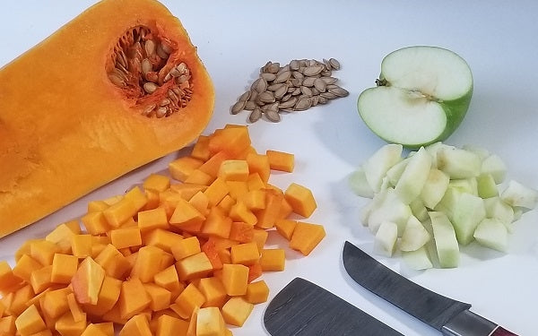 Image of cubed butternut squash, peeled garlic, green apple, and ginger