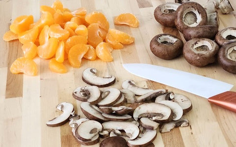 Image of segmented tangerines and sliced mushrooms