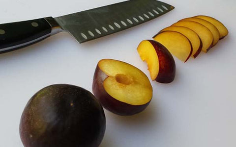 Image of Slice each plum in half, remove pit, then cut into quarters, then slice quarters thin