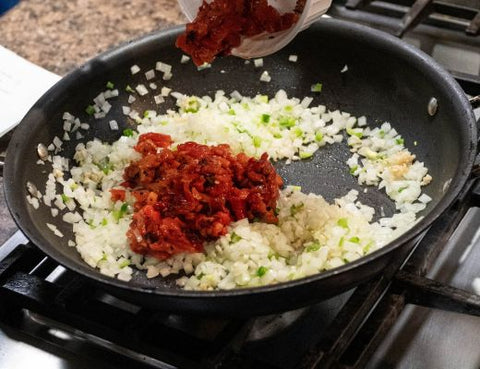 Image of red bell peppers and onions saute