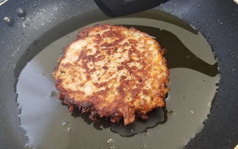 Image of frying fritter in pan