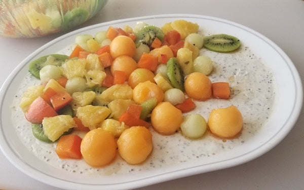 Image of cut and mixed fruit on a plate with yogurt and chia mix