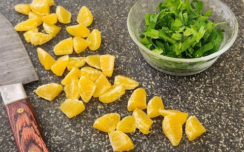 Image of sliced and chopped tangerines and parsley, respectively