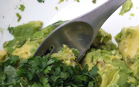 Image of Mash together the avocados, lime juice, cilantro and salt to taste (option: add hot sauce)