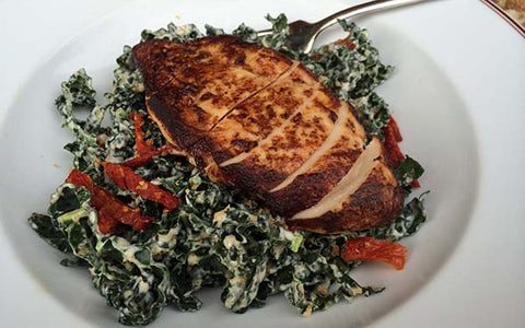 Image of Tuscan Kale Salad with Sun-Dried Tomatoes, Pecorino Cheese and Pan-Seared Chicken Breast in A Lemon-Mustard Vinaigrette