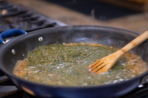 Image of mixing salsa verde with onions in a sauté pan