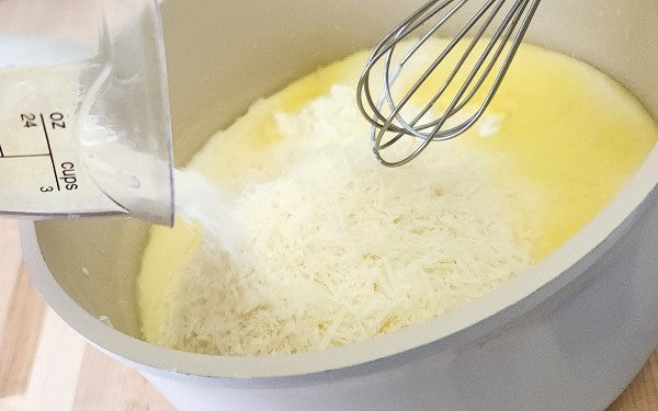 Image of adding cheese to sauce