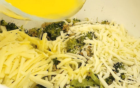 Image of broccoli mixed with cheese