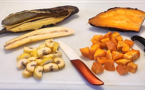 Image of peeled and sliced red sweet potatoes and plantains