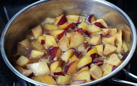 Image of Using the same sauté pan, add in the chopped plums, garlic, stock, soy sauce and ginger powder, then bring the mixture to a simmer