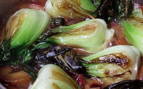 Image of Add all of the bok choy back to the pan, lower the heat to medium-low, cover the pan and braise the bok choy for 5 minutes