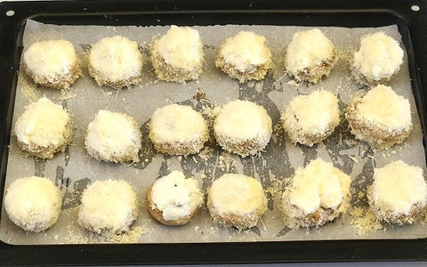 Image of stuffed mushrooms arranged in baking tray with parchment paper