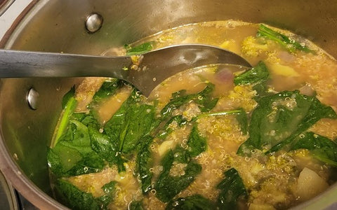 Image of adding spinach to soup