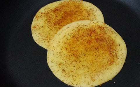 Image of Overlap 2 slices of Provolone cheese sprinkled with Melissa's Hatch Chile Powder in an oiled, preheated, non-stick pan