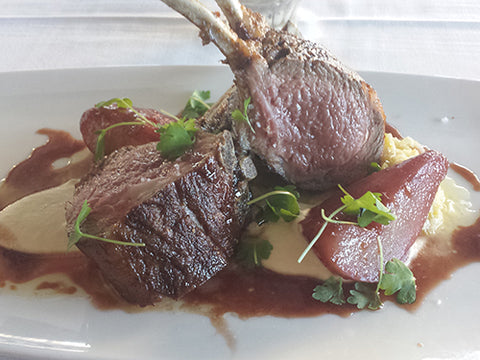 Image of roasted Rack of Lamb with Celery Root Purée, Leek Soubise Sauce and Pomegranate-Poached Pears