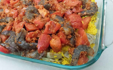 image of tomato/shrimp mixture over paella