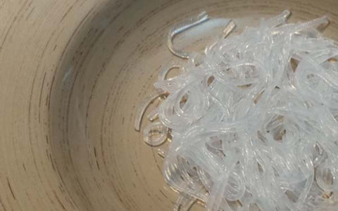 Image of Arrange strained noodles in the bottom of a large soup bowl