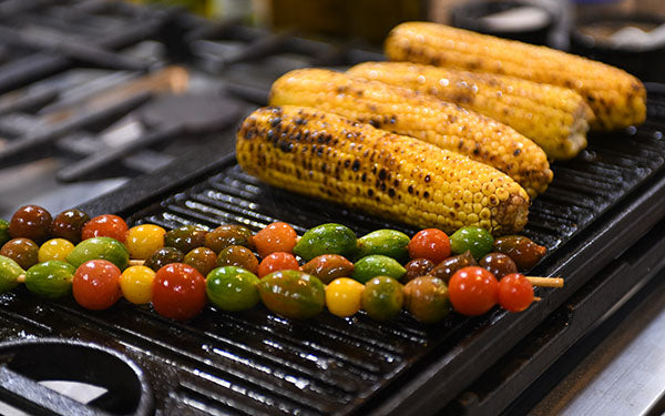 Image of corn and kebabs on the grill