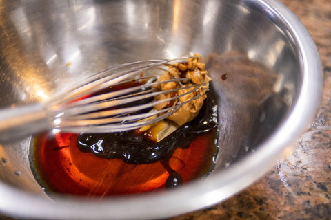 Image of whisking dressing ingredients in a bowl