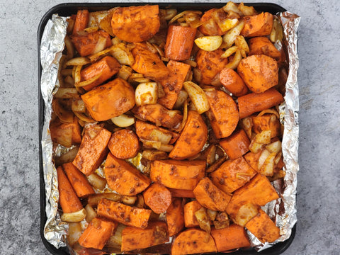 Image of sweet potato pieces in a baking tray for roasting
