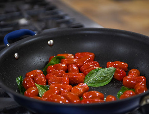 Image of tomatoes and basil in a pan