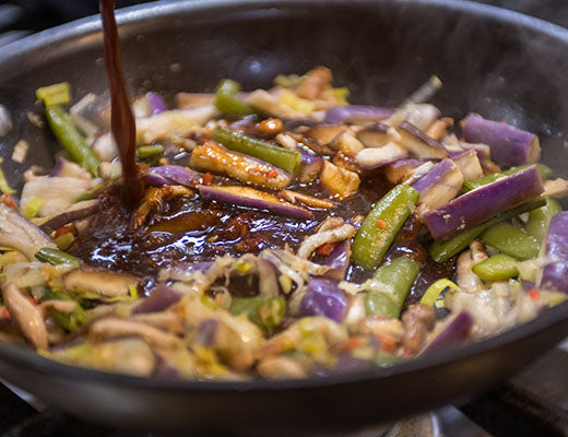 Image of eggplant sauteeing in pan