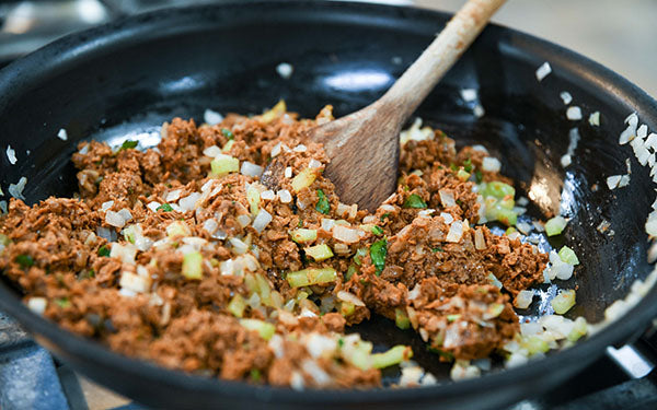 Adding sausage to pan