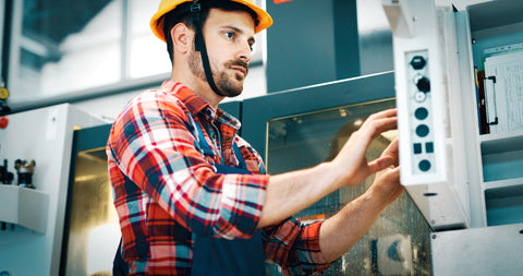 man using cnc machine controls