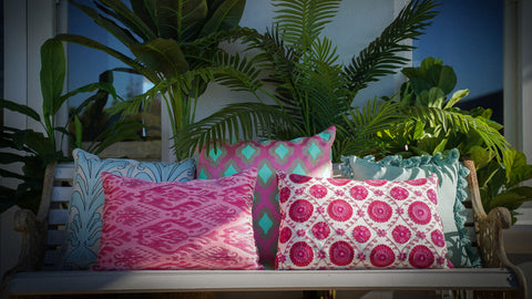 Colourful Cushions sitting on beautiful bed linens