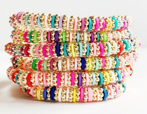 stack of 6 bright rainbow disc and gold bracelets