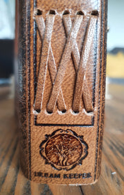 Close up of leather binding on spine of journal with DreamKeeper Tree of Life embossing