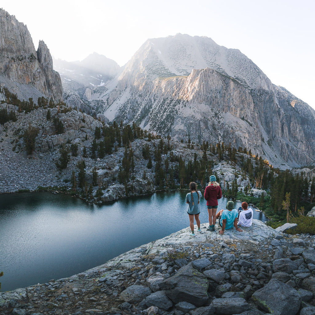 Hiking with friends to an empty lake in the mountains