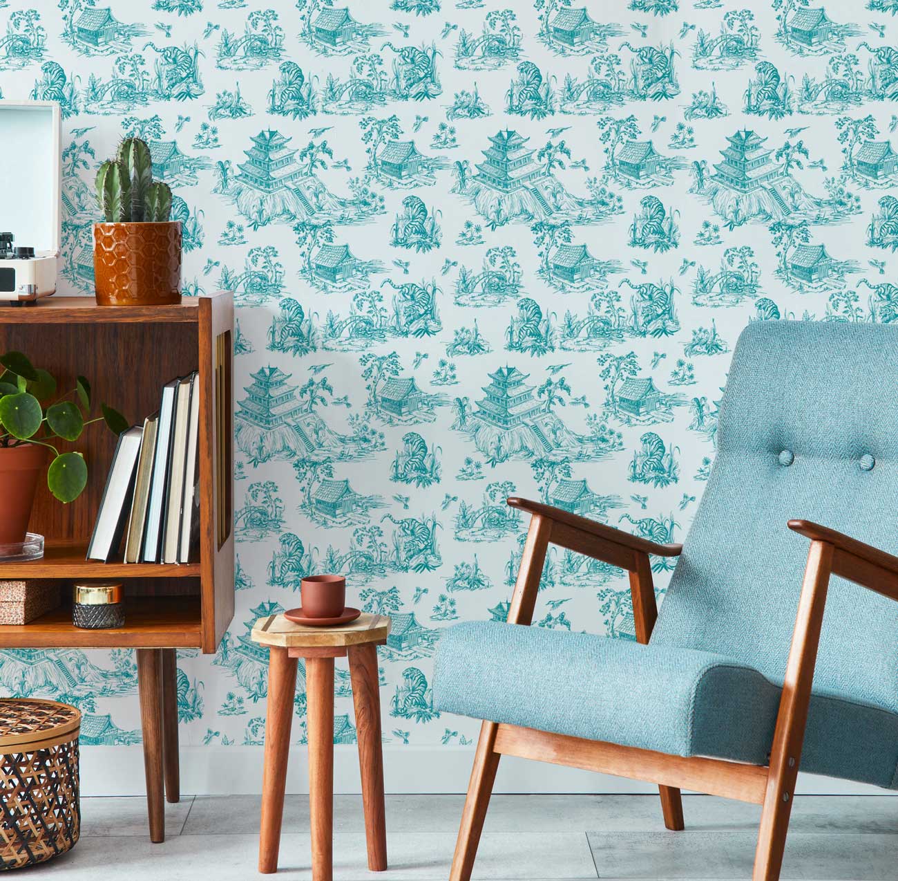 a chinoiserie blue wallpaper pattern in a modern living room
