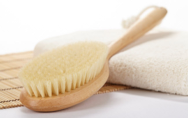 Natural dry skin brush on top of a towel