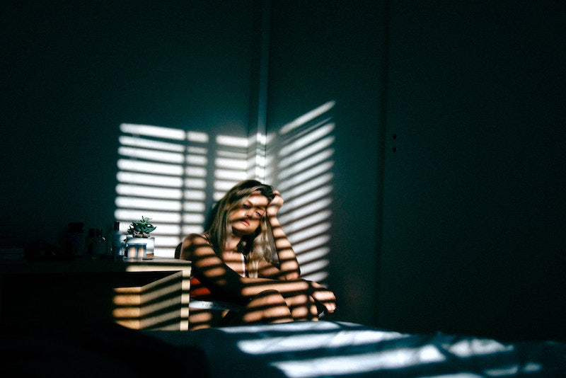 stressed girl sitting in dark room