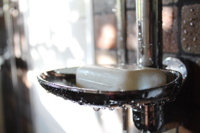 a bar of antibacterial soap on a shower holder