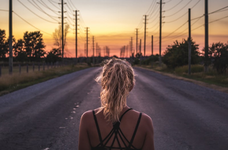 girl walking towards sunset