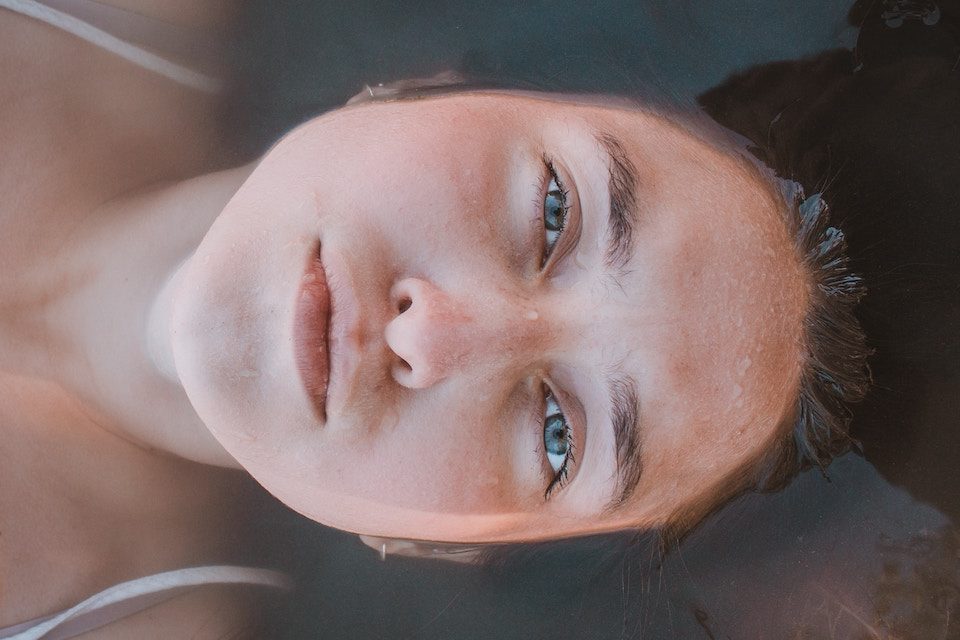 girl with face in water