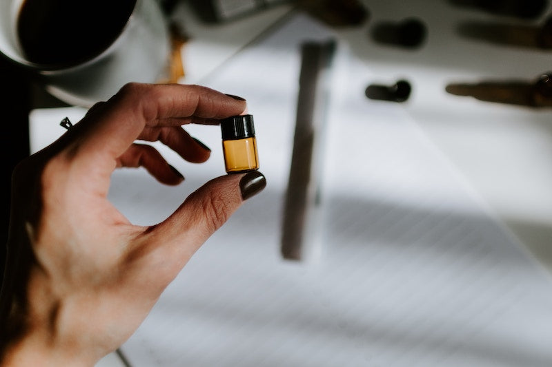 girl holding essential oil bottle