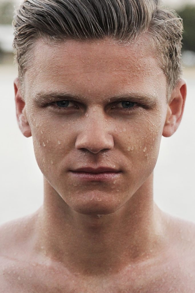 close up of man with water dripping off his face