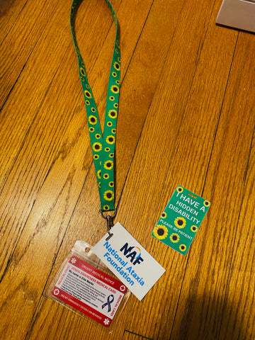 Lanyard with sunflowers and two cards attached to it, one that says "NAF"