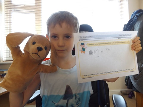 A child holding up home learning 1