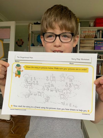 A child holding up home learning 3